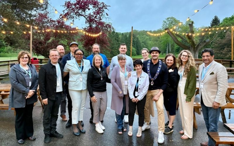 Front, from left to right: Karen Dowhan (member), Cliff Fielder (member), Nadia McCormack-McIntyre (board member), Georgia Raso (board member), Michelle Lupson (member), Angie Wilson (member), Luca Monti (board member), Annette Lee (board member), Joy Gallaiford (member), George Thomas (board member). Back, from left to right: Brian Brennan (guest), Jean-Claude Temperman (member), Alon Shatil (host), Justin Tiseo (host/member).