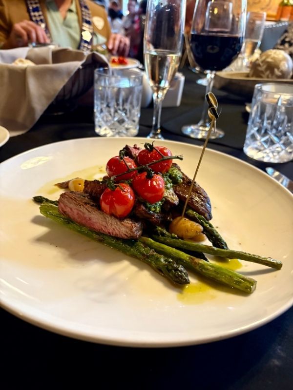 24 Hour Marinated Flank Steak. Grilled cherry tomatoes on the vine, chimichurri sauce.